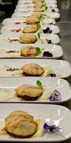 Dessert of pears in pastry with caramel sauce
